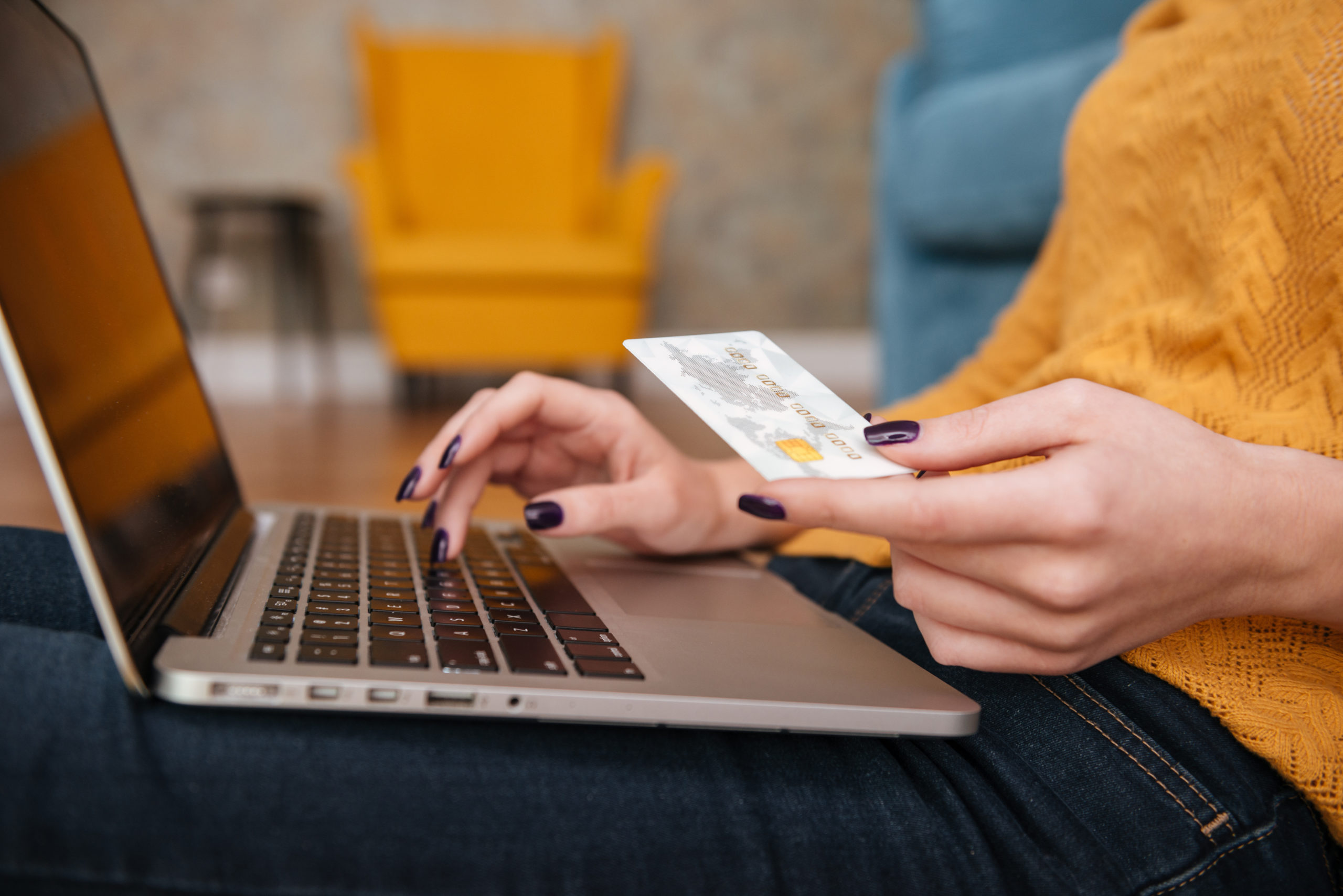 Close up of a woman buying online with bank card Odrudej współpraca